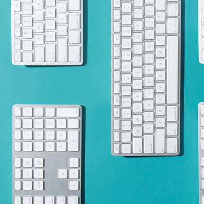 Silver And White Keyboards Flat Lay