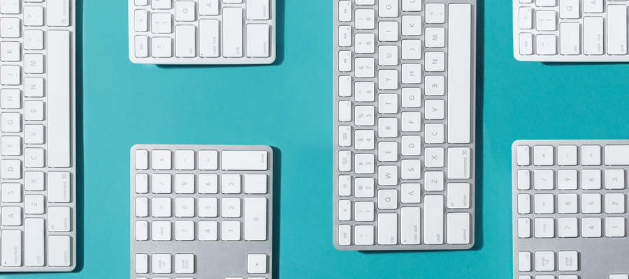 Silver And White Keyboards Flat Lay